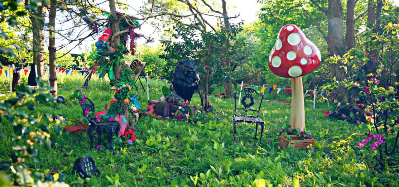 An-Enchanted-Garden-Theme-Outdoor-Event-Space-With-Lion-And-Toadstool