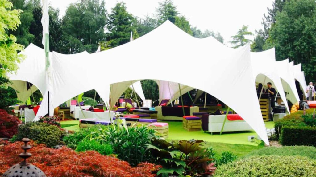 An outdoor festival event with a bold white marquee.