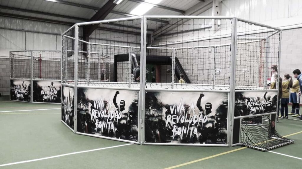 A 1v1 football cage at an indoor event.