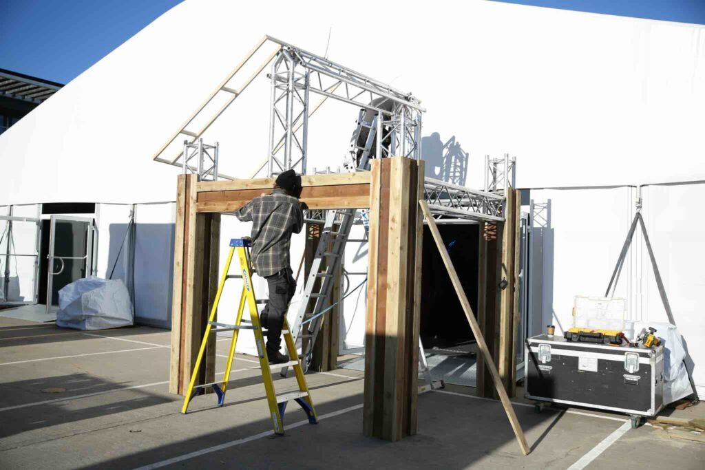 A tent entrance being put up for the Gymshark Lodge event.