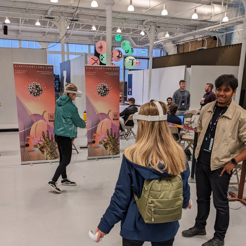 People engaging with our VR game at an event, awaiting turns and walking around the space.