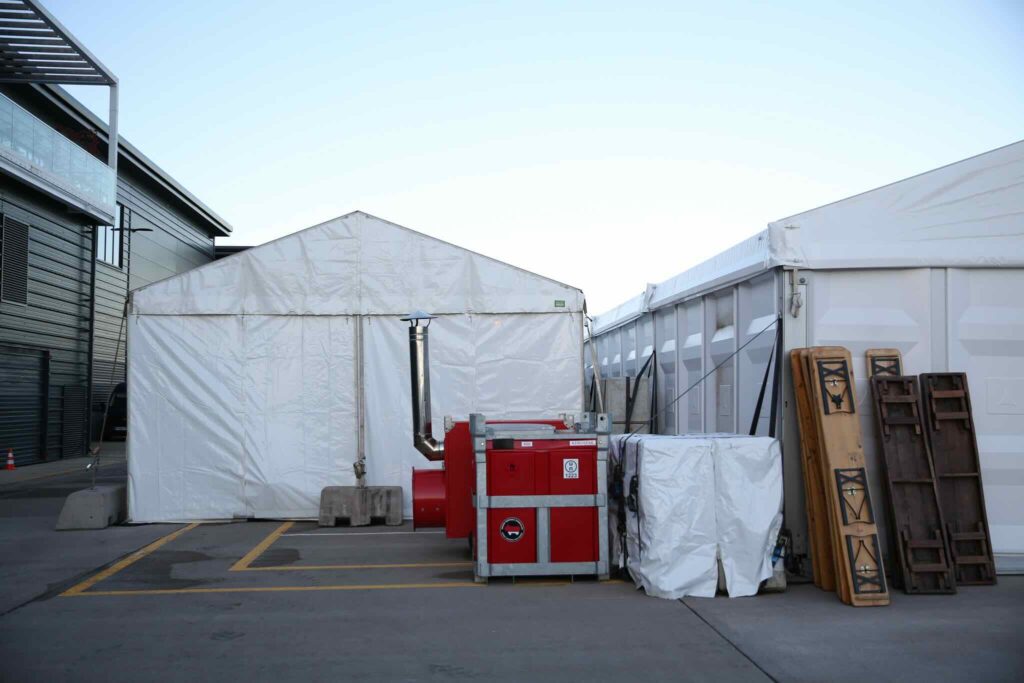 An outdoor event tent and generators for a Gymshark event.