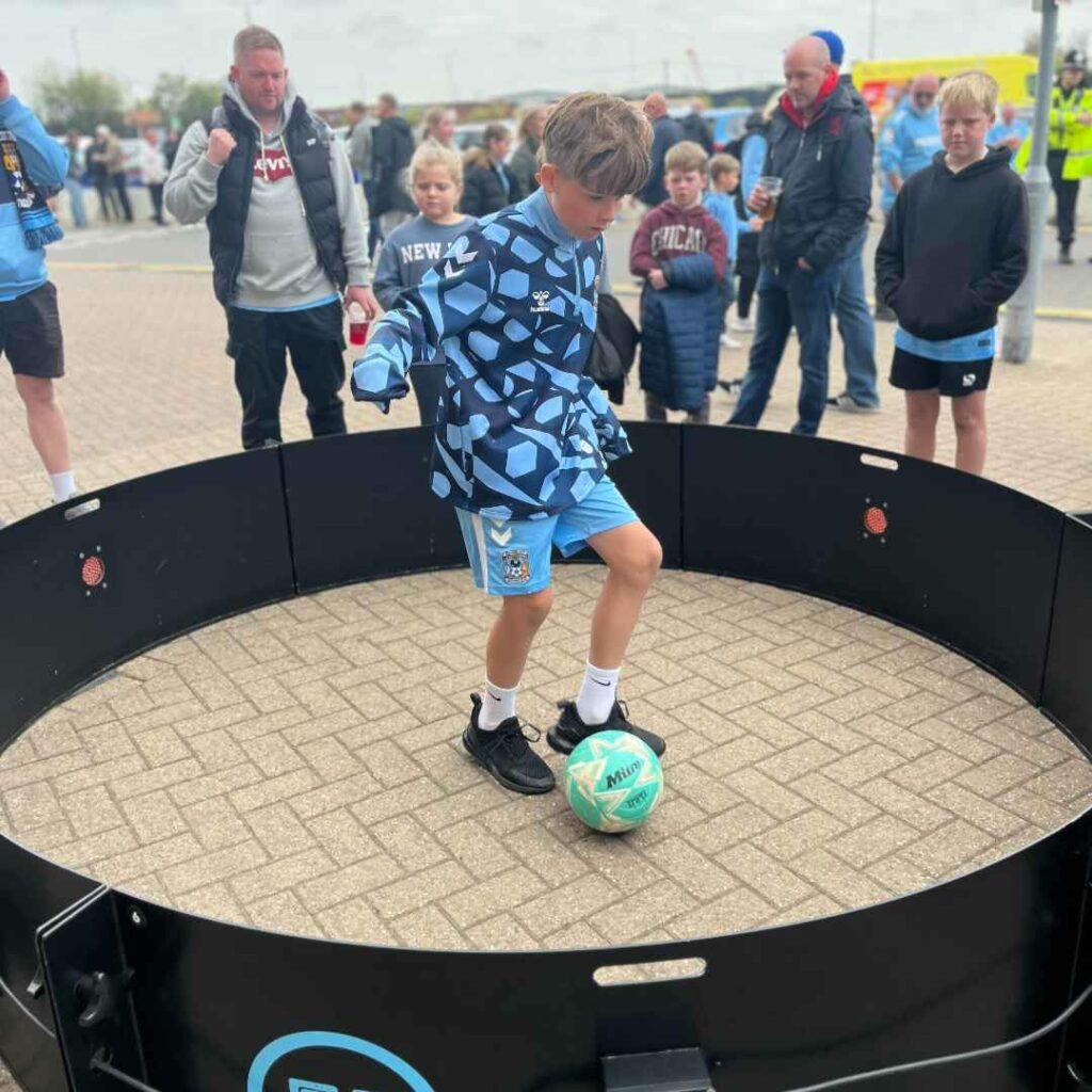 A child taking part in our fast feet football game at an outdoor event.