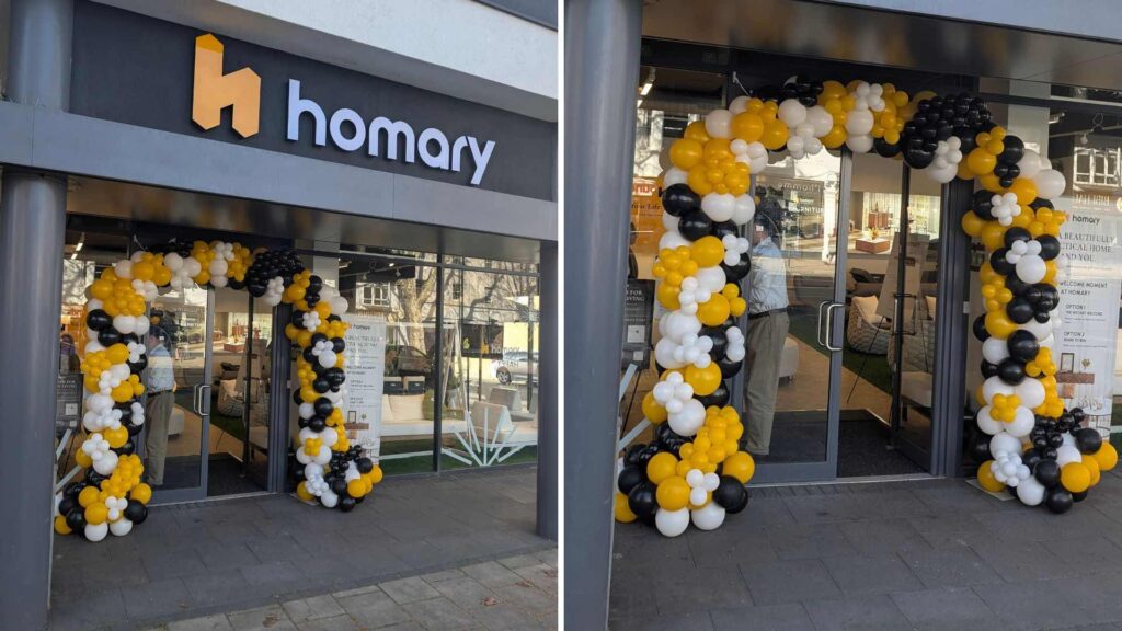 Homary yellow, white and black balloon arch entrance at London Chiswick.