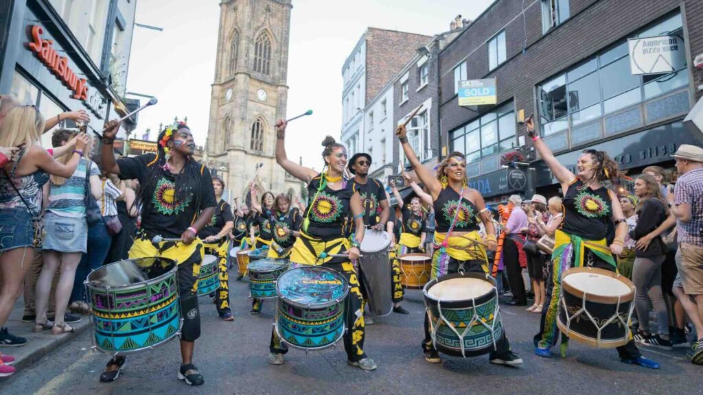 A carnival drumming band performing at a public event.