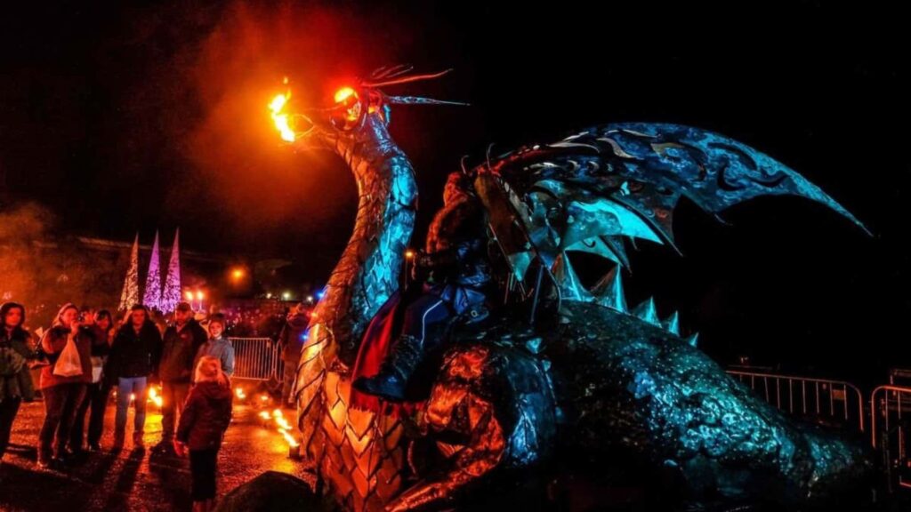 Walkabout fire breathing dragon puppet entertaining families at parade event