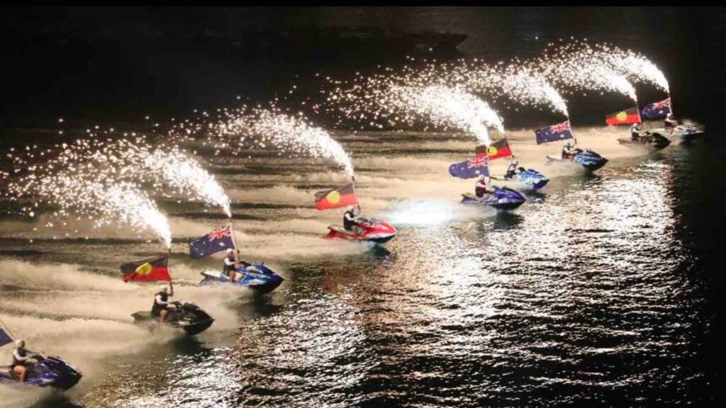 Global water stunt show performing with flags from an array of countries.