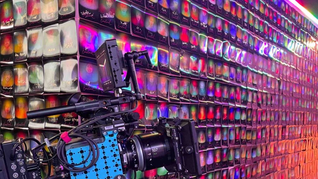 Aura photography print out wall with camera.