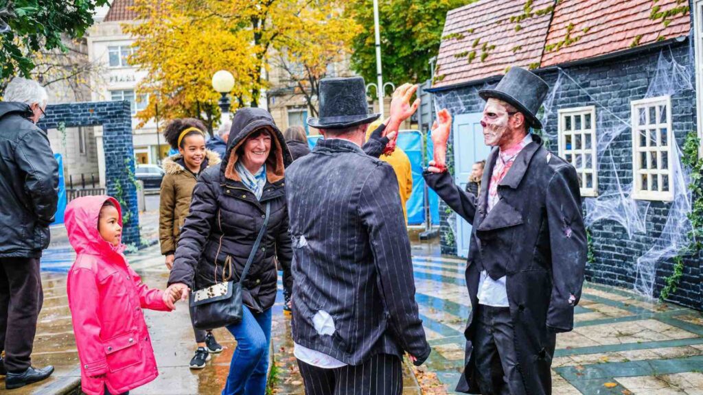 A Halloween roaming character interacting with guests.