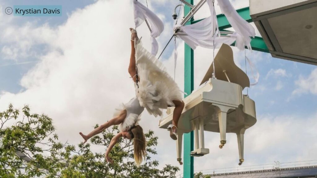 Flying piano aerialist at the UEL festival event 2026 created as a bespoke act by Julia Charles Event Management.