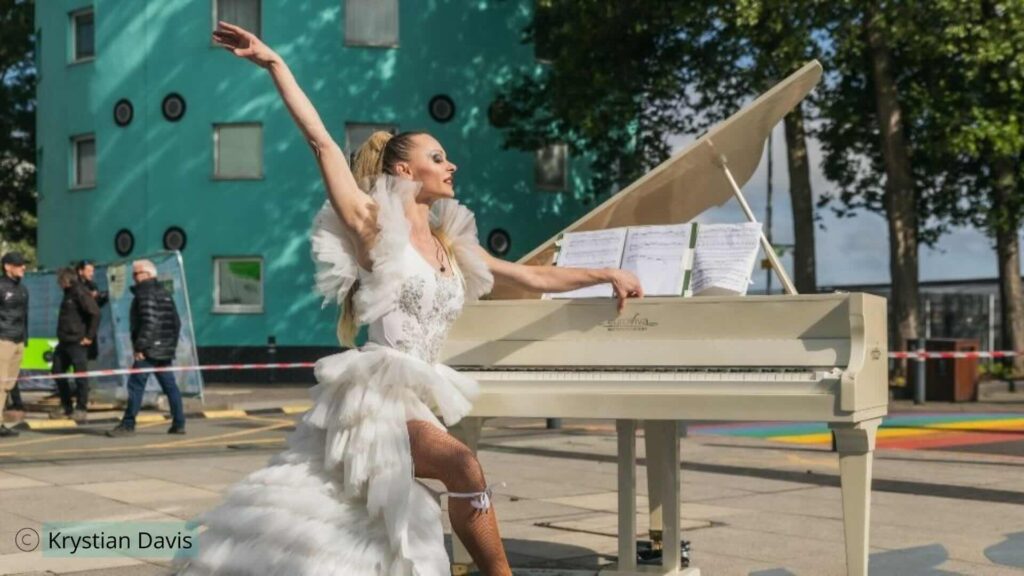 Flying piano aerialist at the UEL festival event 2026 created as a bespoke act by Julia Charles Event Management.