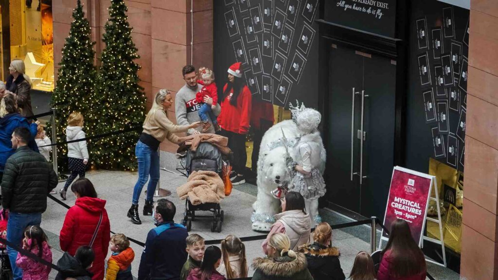 Interactive installations at a shopping centre featuring a polar bear surrounded by families.