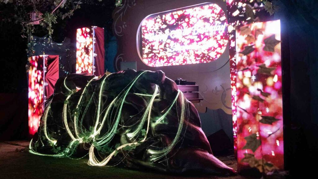 A bespoke themed event with multi-color lighting and a stage set-up.
