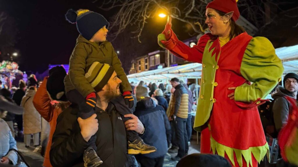Cheeky stilt walking elves interacting with youngsters and children at Christmas events.