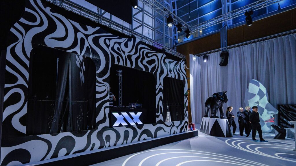 Custom scenic set design transforming an event venue into a fully branded world