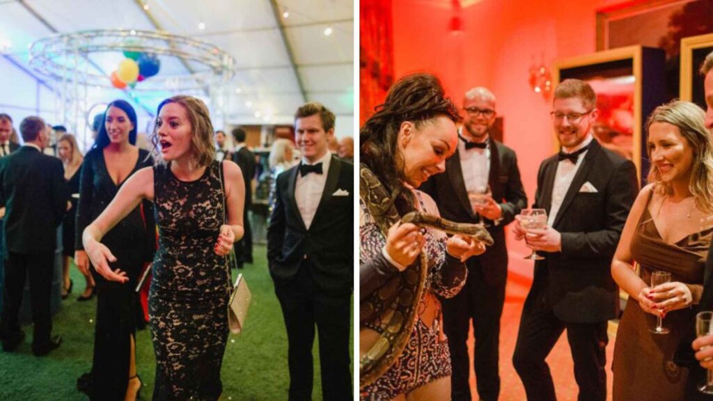 Guests at a corporate circus themed Christmas party with aerial hoop rigging and a snake charmer performer.