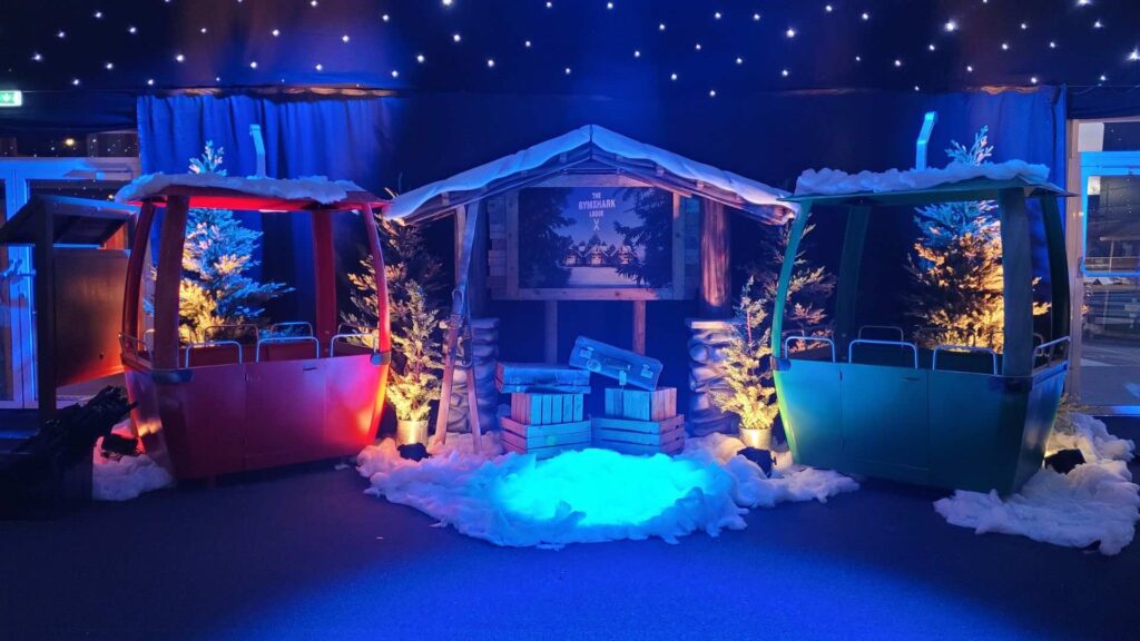 Alpine cable car gondolas and ski station scenic set at a corporate Christmas party