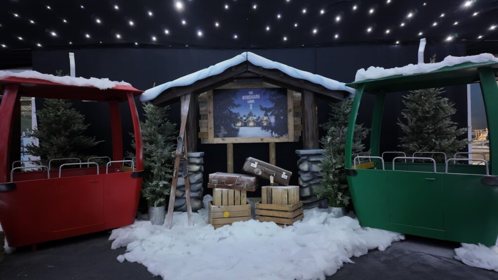 Cable car props with faux snow at a corporate Christmas party