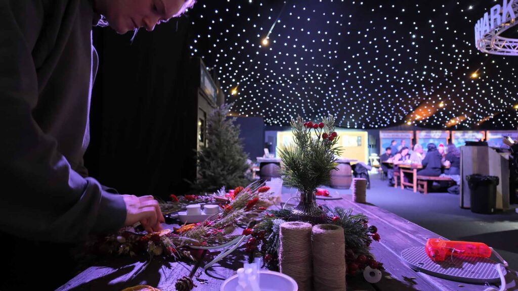 Dried flower and foliage wreath making at an Alpine Lodge themed corporate Christmas party