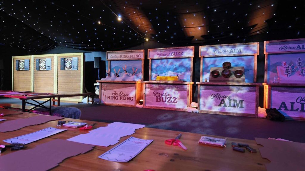 Alpine themed games including Ski Slope Ring Fling and Alpine Aim at a corporate Christmas party