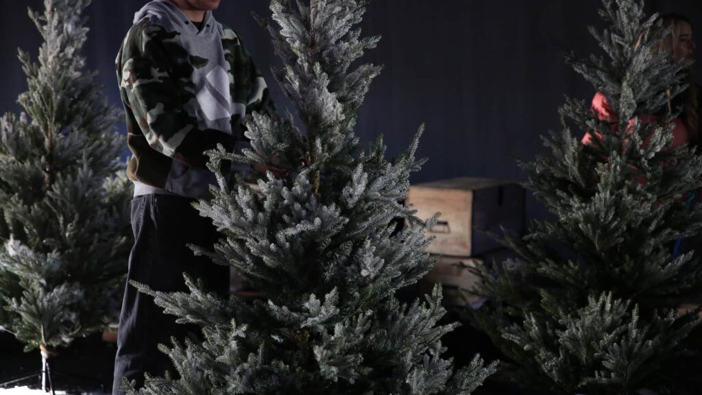 dressing flocked Christmas trees during a corporate event build