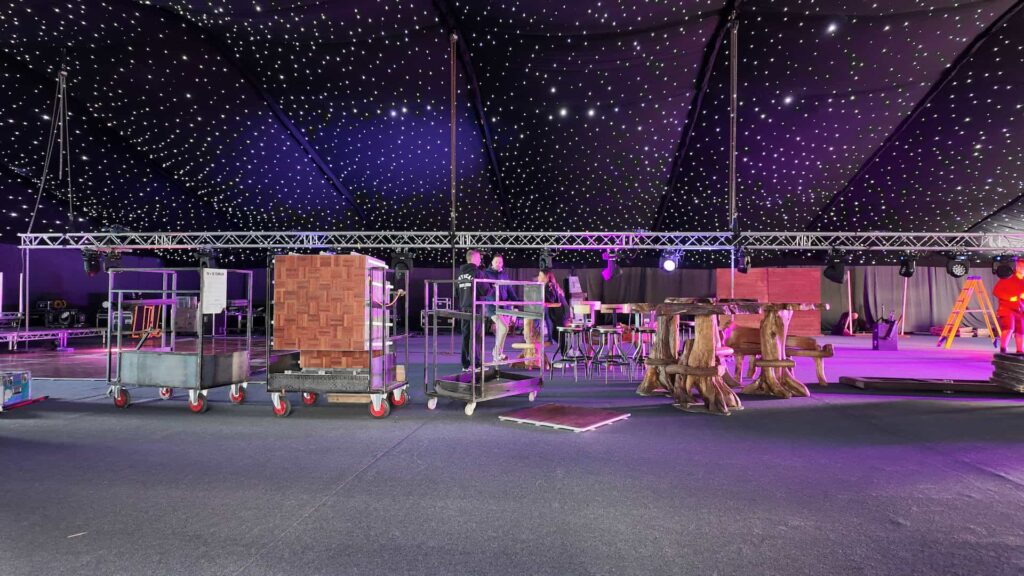 Corporate Christmas event build in progress beneath a starcloth ceiling