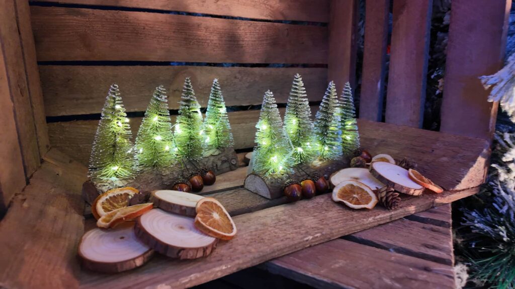 Alpine Christmas props with miniature trees and log slices
