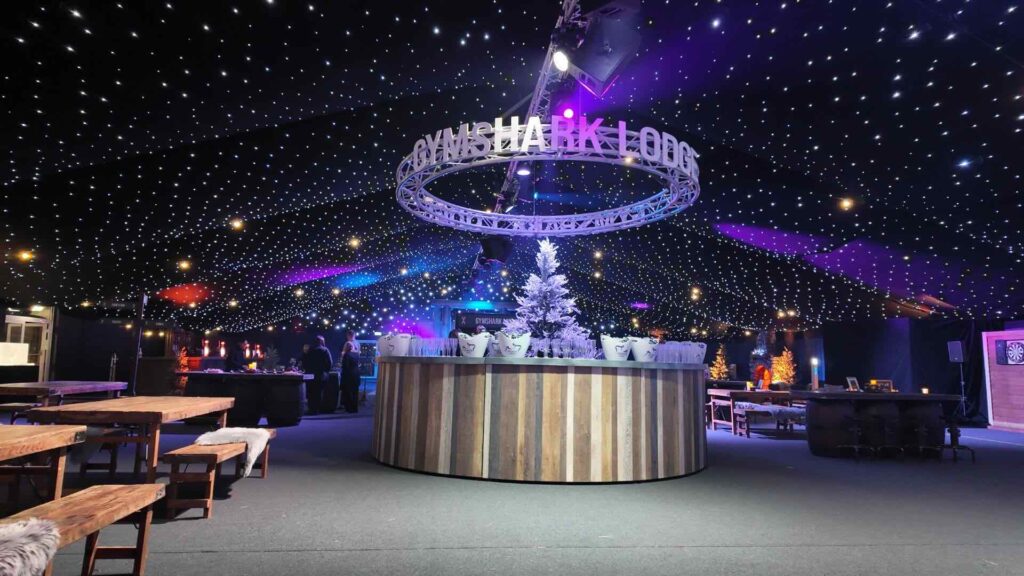 Alpine lodge themed event with rustic timber styling, warm lighting and luxury lounge seating.