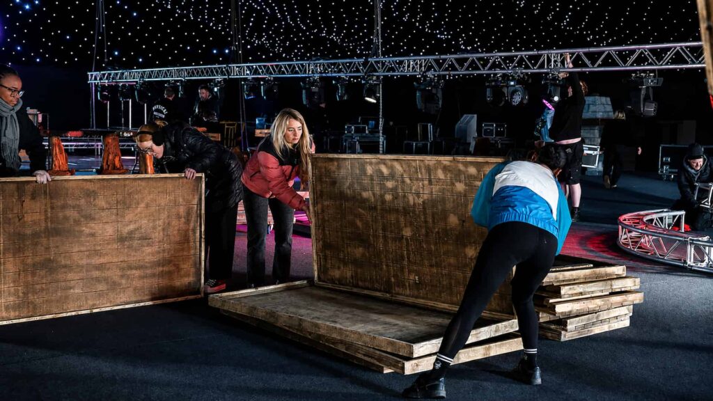 Gymshark Christmas party event build with crew installing set flats and staging