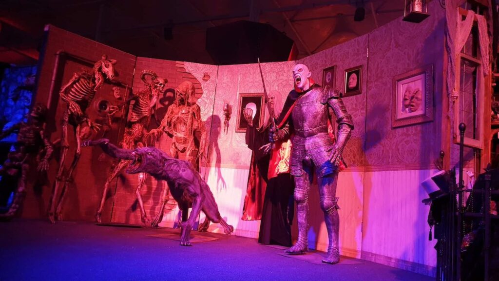 Immersive Halloween set with dressed walls, layered props and theatrical lighting at the Saudi Arabia Horror Festival