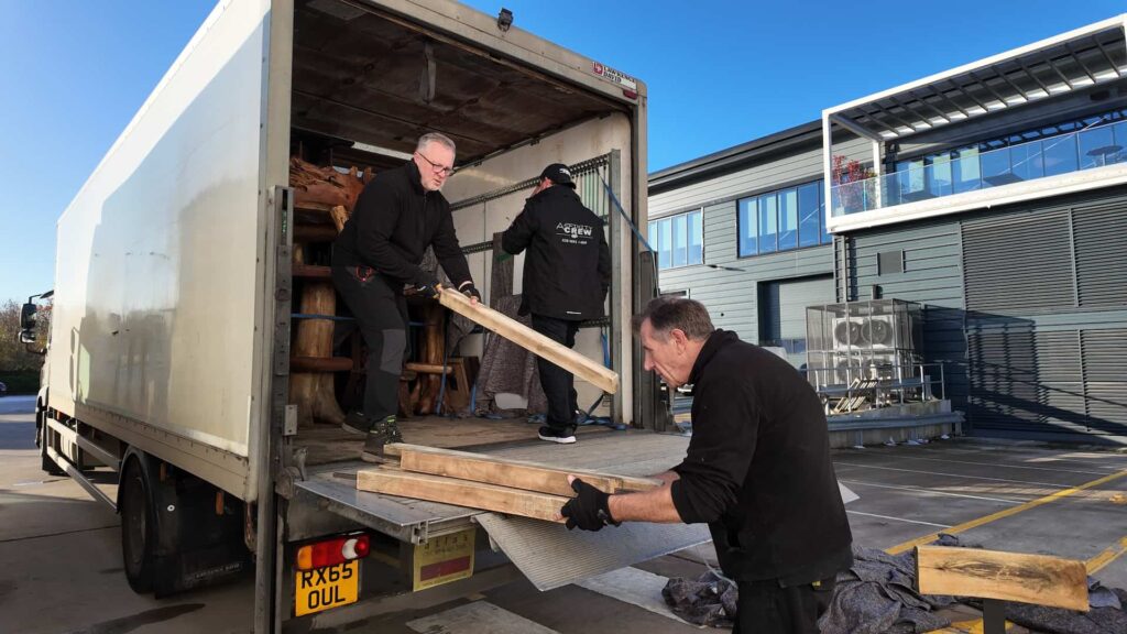 Crew unloading timber set pieces from a delivery lorry during the Gymshark Christmas party