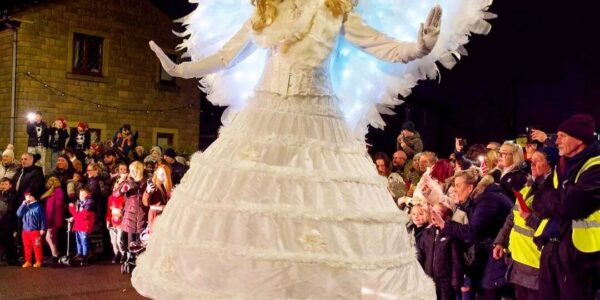 illuminated-angel-stilt-walker-night-street