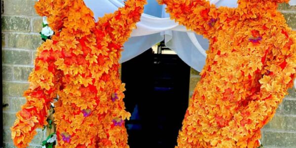 Autumn-Leaf-Men-High-Five-Under-Floral-Arch