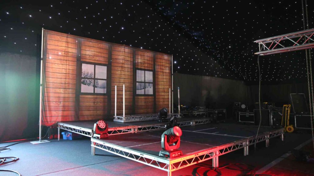 Bespoke wooden stage set with lighting and technical production inside the Gymshark Christmas venue