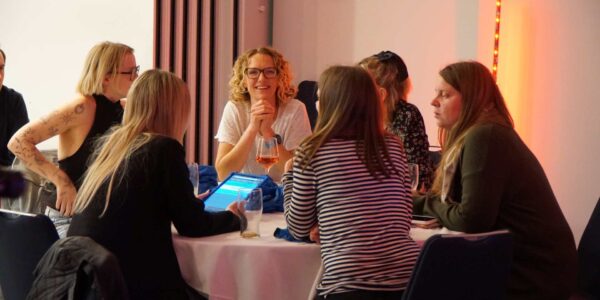 Corporate-Christmas-Quiz-Team-Playing-On-Tablet