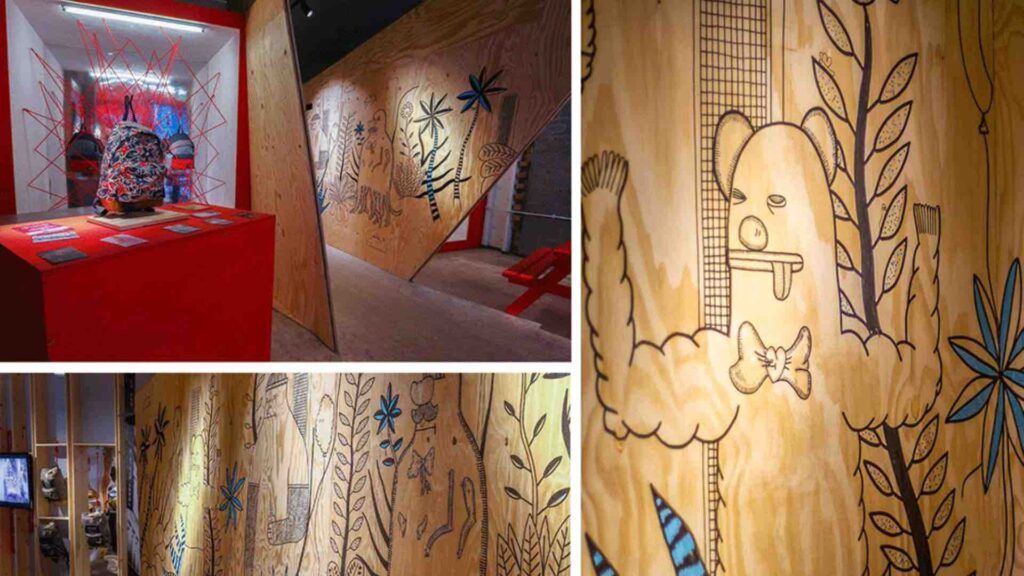Collage of a hand-drawn mural of plants and cartoon characters on plywood walls, beside a red plinth displaying a patterned backpack