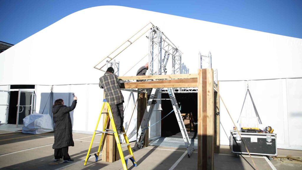 Production suppliers building a bespoke entrance inside the Gymshark Christmas event venue